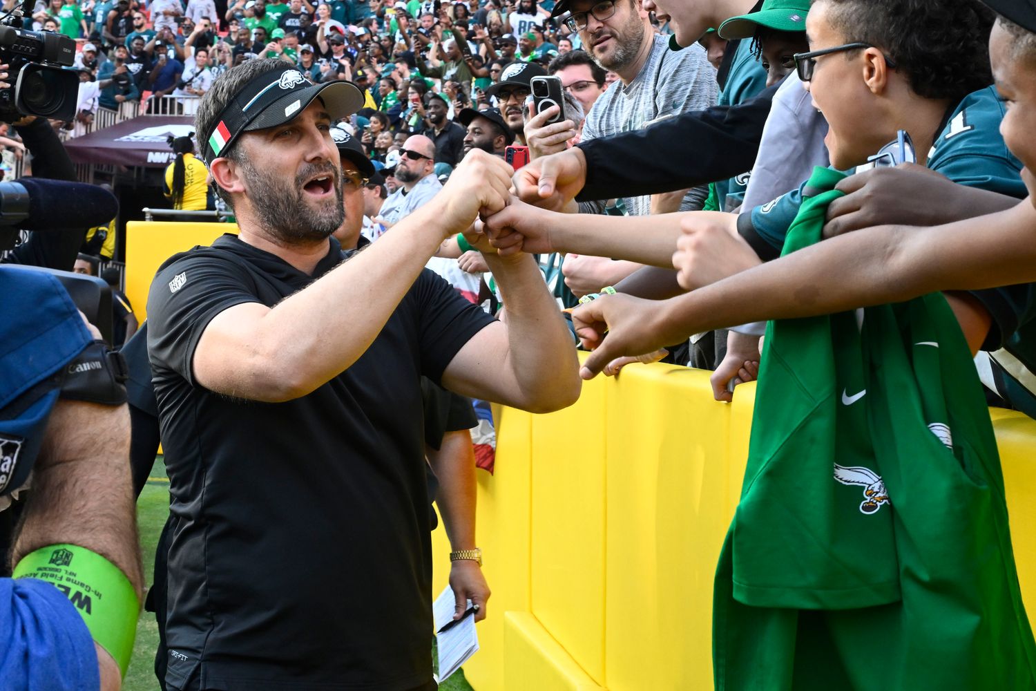 Philadelphia Eagles head coach Nick Sirianni celebrates with fans after the game against the Washington Commanders at FedExField.